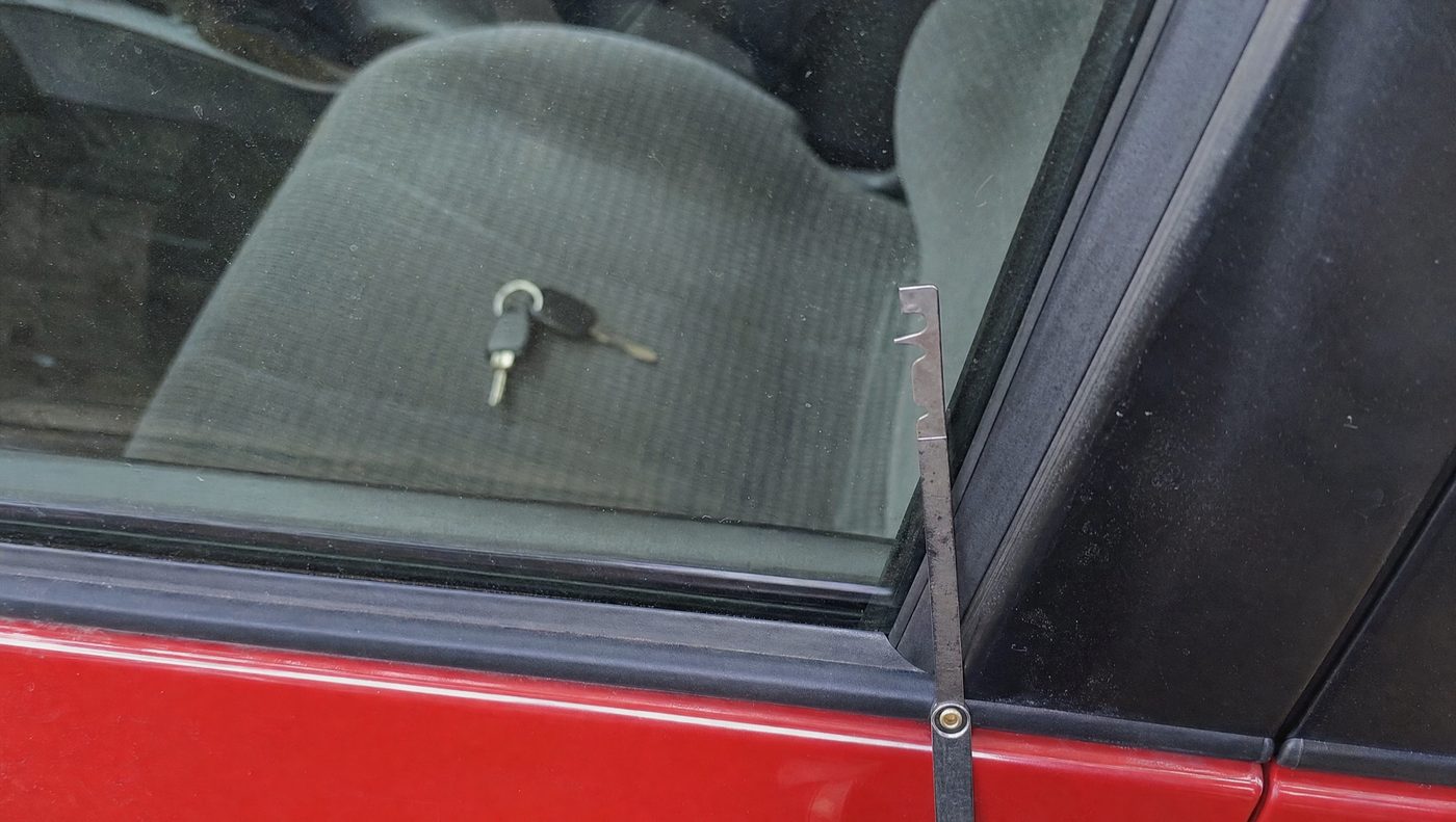 Close-up of a car window with keys visible locked inside
